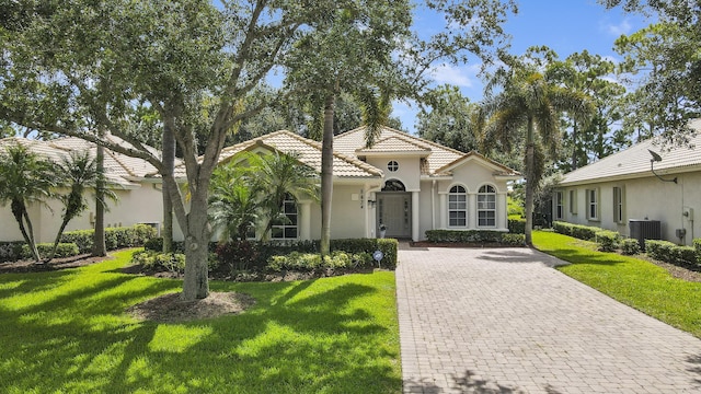 mediterranean / spanish-style house featuring a front yard