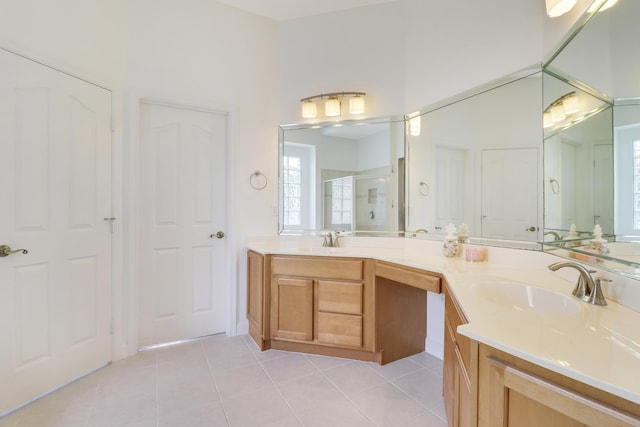 bathroom with tile patterned flooring, vanity, and a shower with shower door