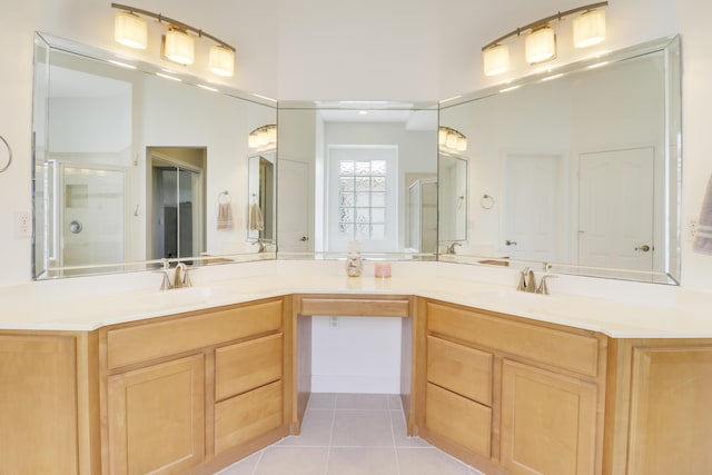 bathroom featuring tile patterned flooring, vanity, and an enclosed shower