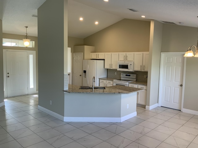 kitchen with sink, backsplash, stone countertops, white appliances, and white cabinets