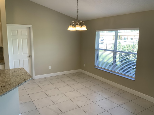 unfurnished dining area featuring a chandelier and light tile patterned floors