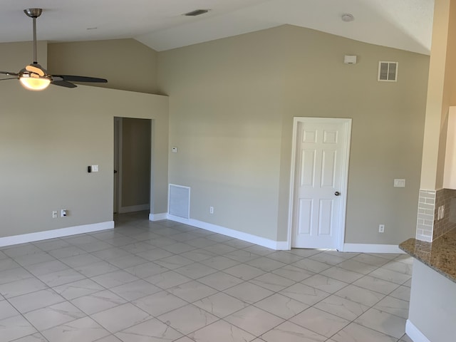 unfurnished room with ceiling fan and high vaulted ceiling