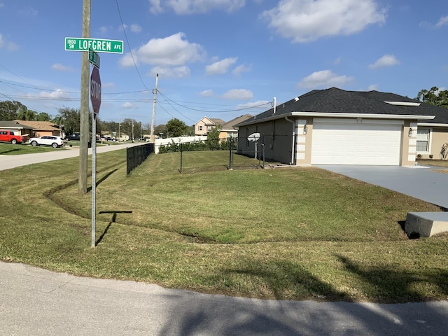 exterior space with a garage and a lawn