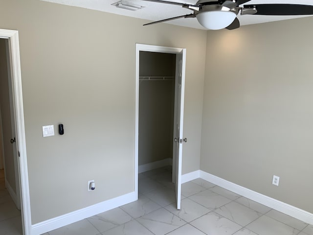 unfurnished bedroom featuring ceiling fan and a closet