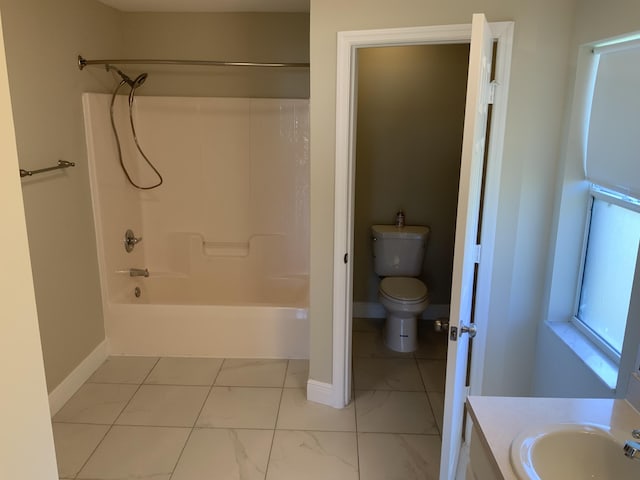 full bath featuring baseboards, vanity, toilet, and bathing tub / shower combination