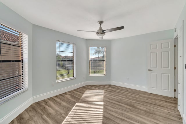 spare room featuring light hardwood / wood-style flooring and ceiling fan