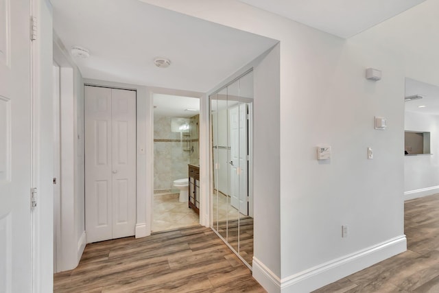 hall with hardwood / wood-style floors