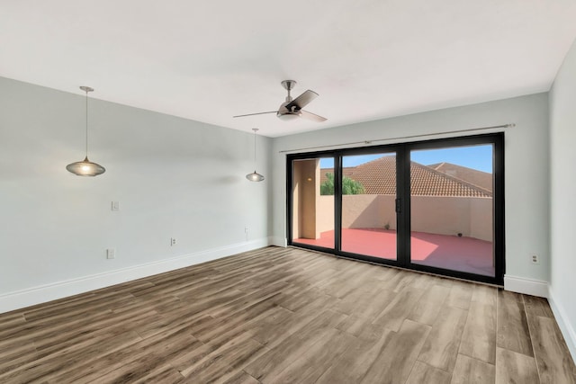 unfurnished room with ceiling fan and hardwood / wood-style flooring