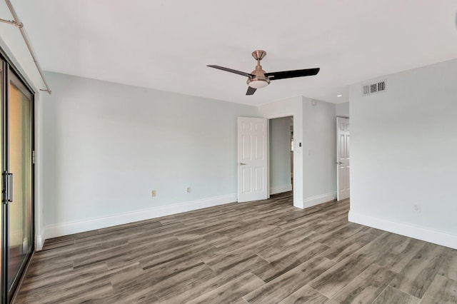 unfurnished bedroom featuring hardwood / wood-style floors, a closet, and ceiling fan