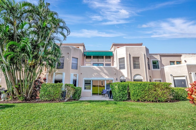 rear view of property with a yard