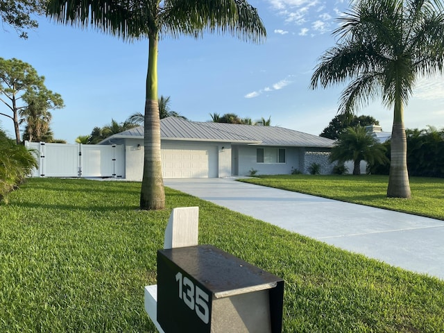 view of front of property featuring a garage and a front yard