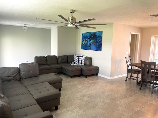 tiled living room featuring a textured ceiling and ceiling fan