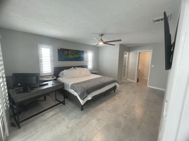 bedroom featuring ceiling fan and a textured ceiling