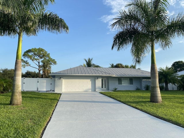 single story home featuring a garage and a front yard