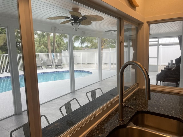 view of pool featuring ceiling fan and sink