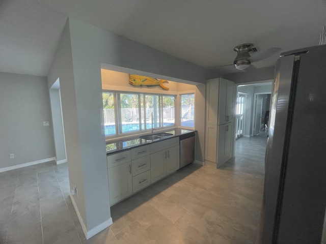 kitchen featuring ceiling fan, sink, lofted ceiling, and appliances with stainless steel finishes