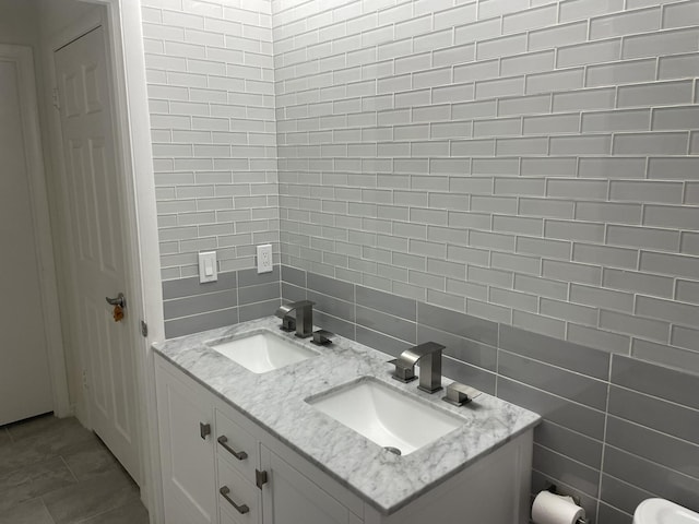 bathroom with vanity and tile walls