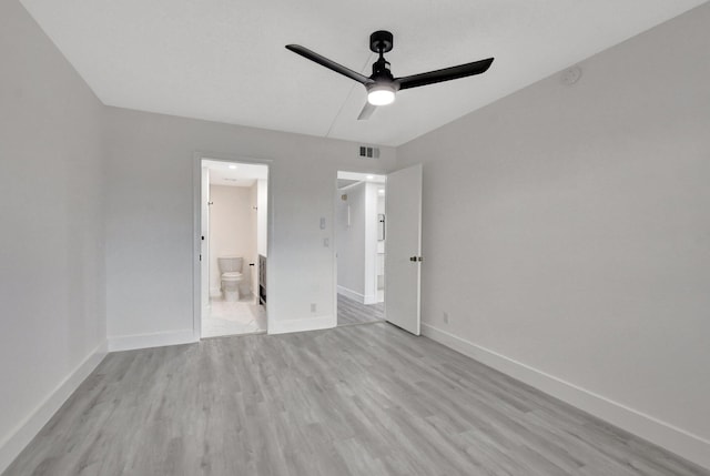 unfurnished bedroom with ceiling fan, ensuite bathroom, and light wood-type flooring