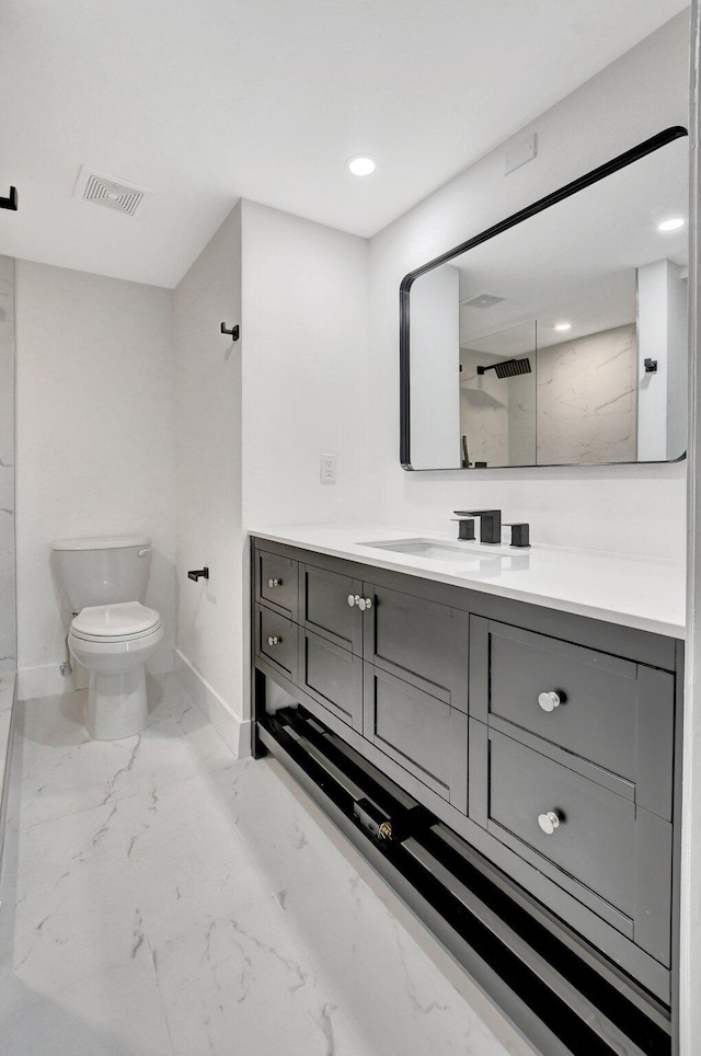 bathroom featuring vanity, toilet, and walk in shower