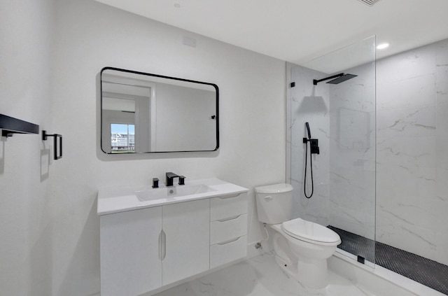 bathroom with vanity, toilet, and a shower with door