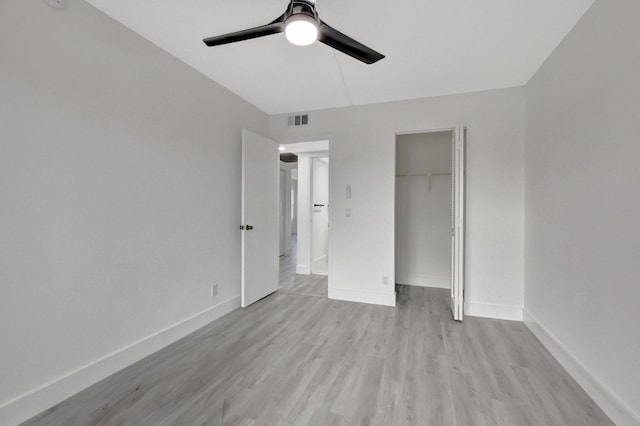 unfurnished bedroom featuring light wood-type flooring, a closet, and ceiling fan