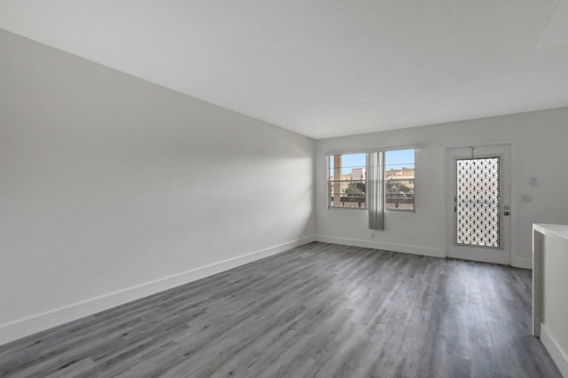 empty room with dark wood-type flooring