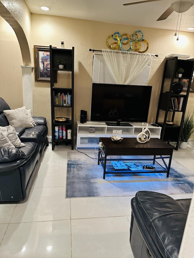 tiled living room featuring ceiling fan