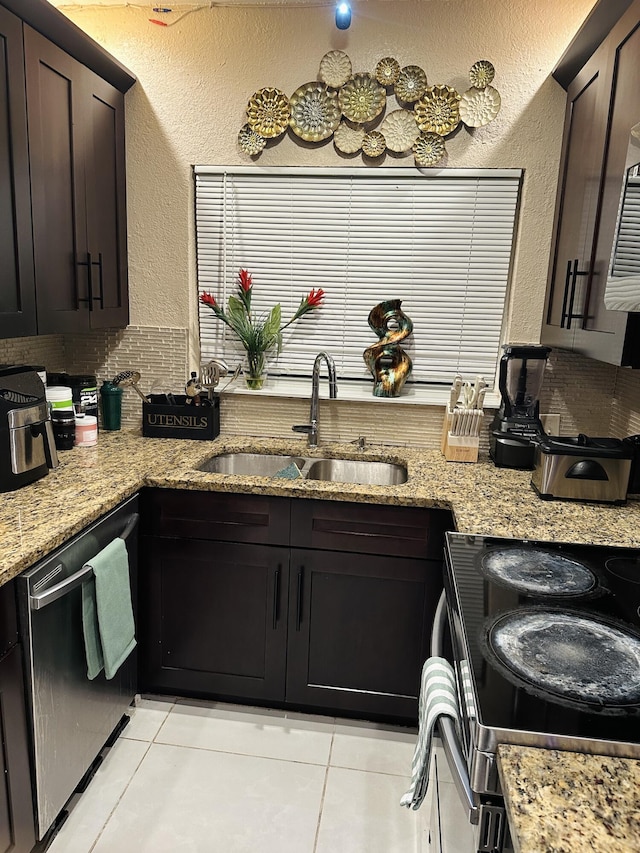 kitchen with sink, light tile patterned floors, stainless steel dishwasher, and dark brown cabinets