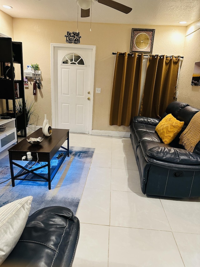 living room with light tile patterned floors and ceiling fan