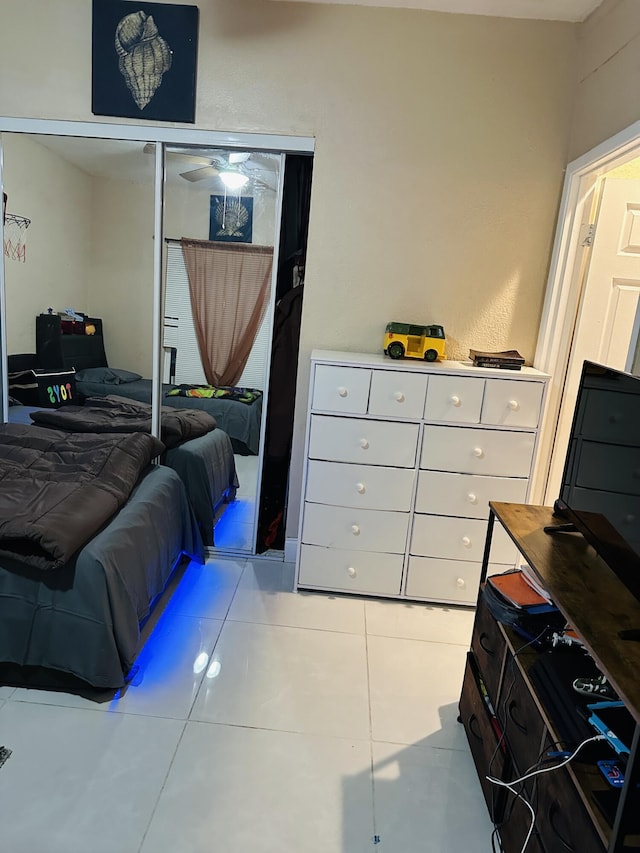 tiled bedroom with a closet