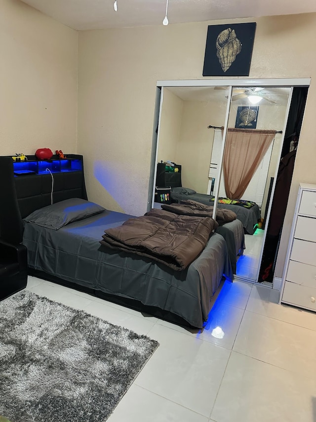 tiled bedroom featuring a closet