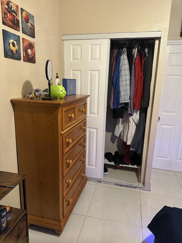 interior space with a closet and light tile patterned flooring