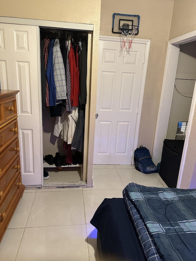 tiled bedroom featuring a closet