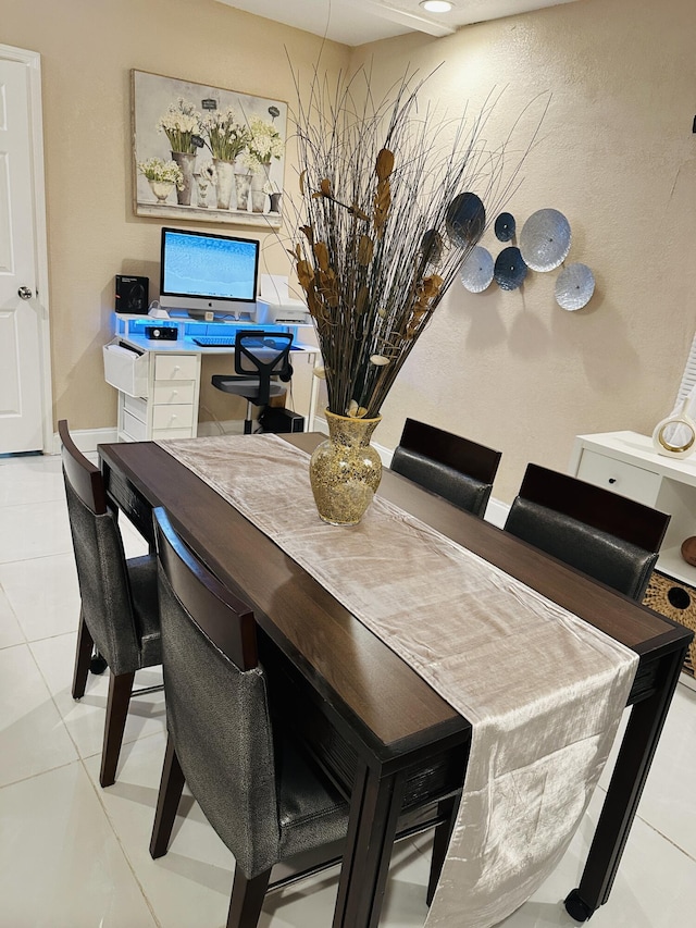 dining area with light tile patterned floors and built in desk