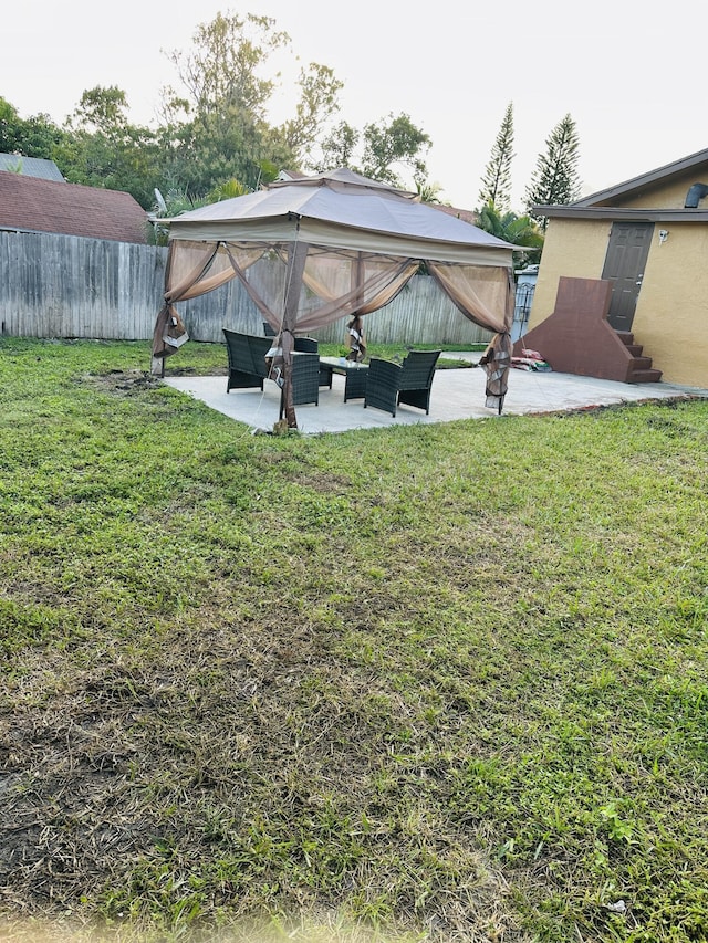 view of yard featuring outdoor lounge area, a gazebo, and a patio