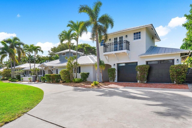 view of front of house with a garage and a balcony