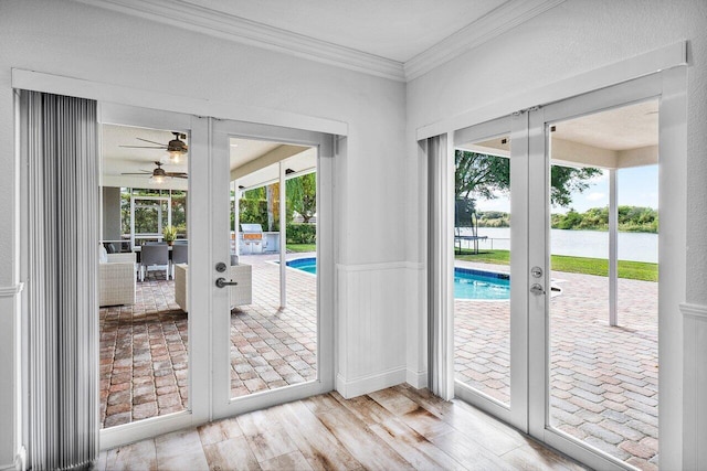 entryway with ceiling fan, french doors, plenty of natural light, and ornamental molding