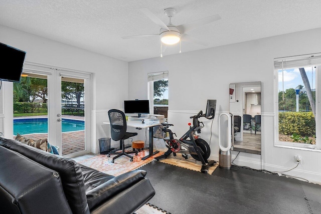 home office featuring a textured ceiling, ceiling fan, and french doors