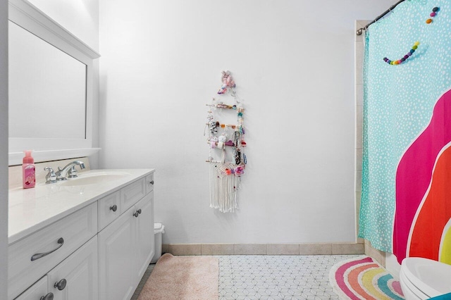 bathroom featuring toilet, vanity, tile patterned flooring, and a shower with shower curtain