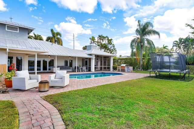 view of swimming pool with a trampoline, a patio area, ceiling fan, an outdoor hangout area, and french doors