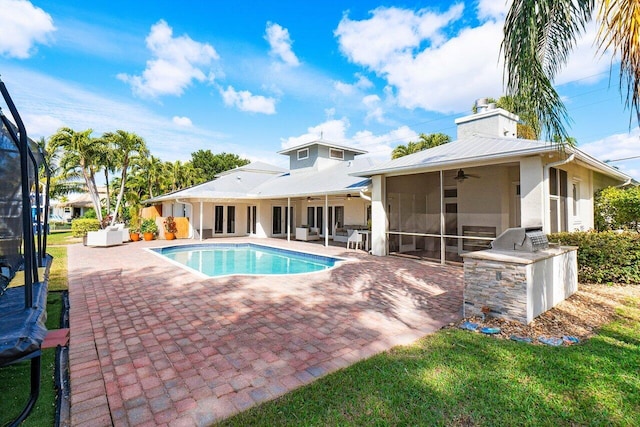 view of swimming pool featuring ceiling fan, a sunroom, a patio, and area for grilling