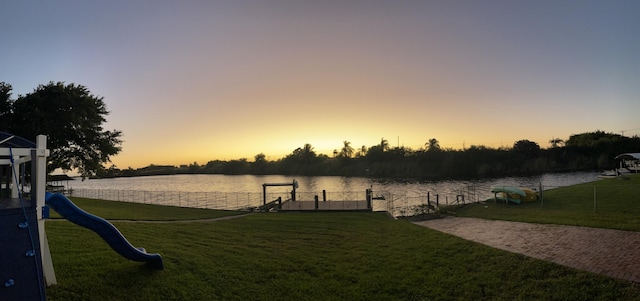 view of dock featuring a water view and a lawn