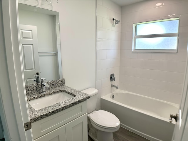 full bathroom with wood-type flooring, vanity, toilet, and tiled shower / bath