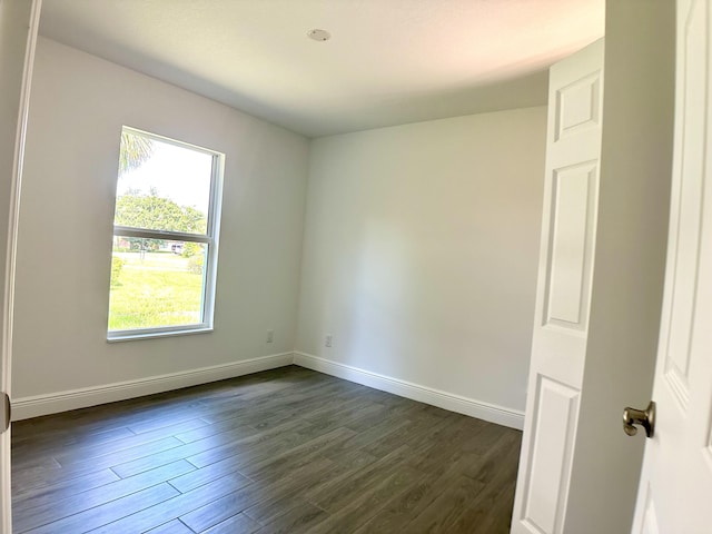 empty room with dark hardwood / wood-style floors