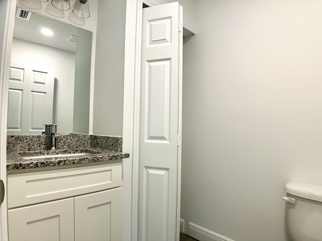 bathroom featuring vanity and toilet