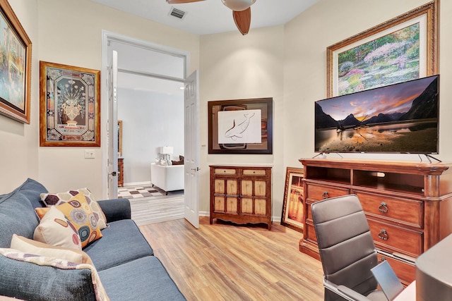 office space featuring ceiling fan and light wood-type flooring