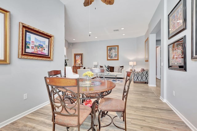 dining area with ceiling fan and light hardwood / wood-style floors