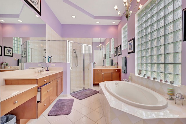 bathroom featuring tile patterned floors, vanity, separate shower and tub, and an inviting chandelier