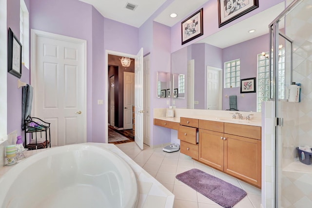 bathroom with tile patterned floors, vanity, and separate shower and tub