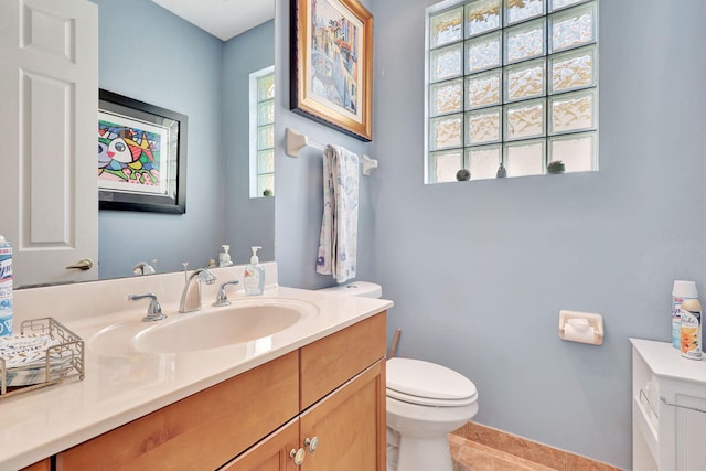 bathroom featuring tile patterned flooring, vanity, and toilet